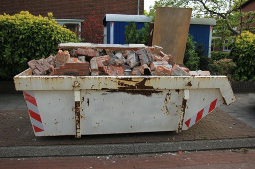 Construction site with waste materials for clearance in Dalston